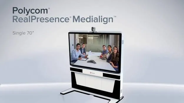 Polycom RealPresence Medialign system displays five people seated around a conference table on a large screen.