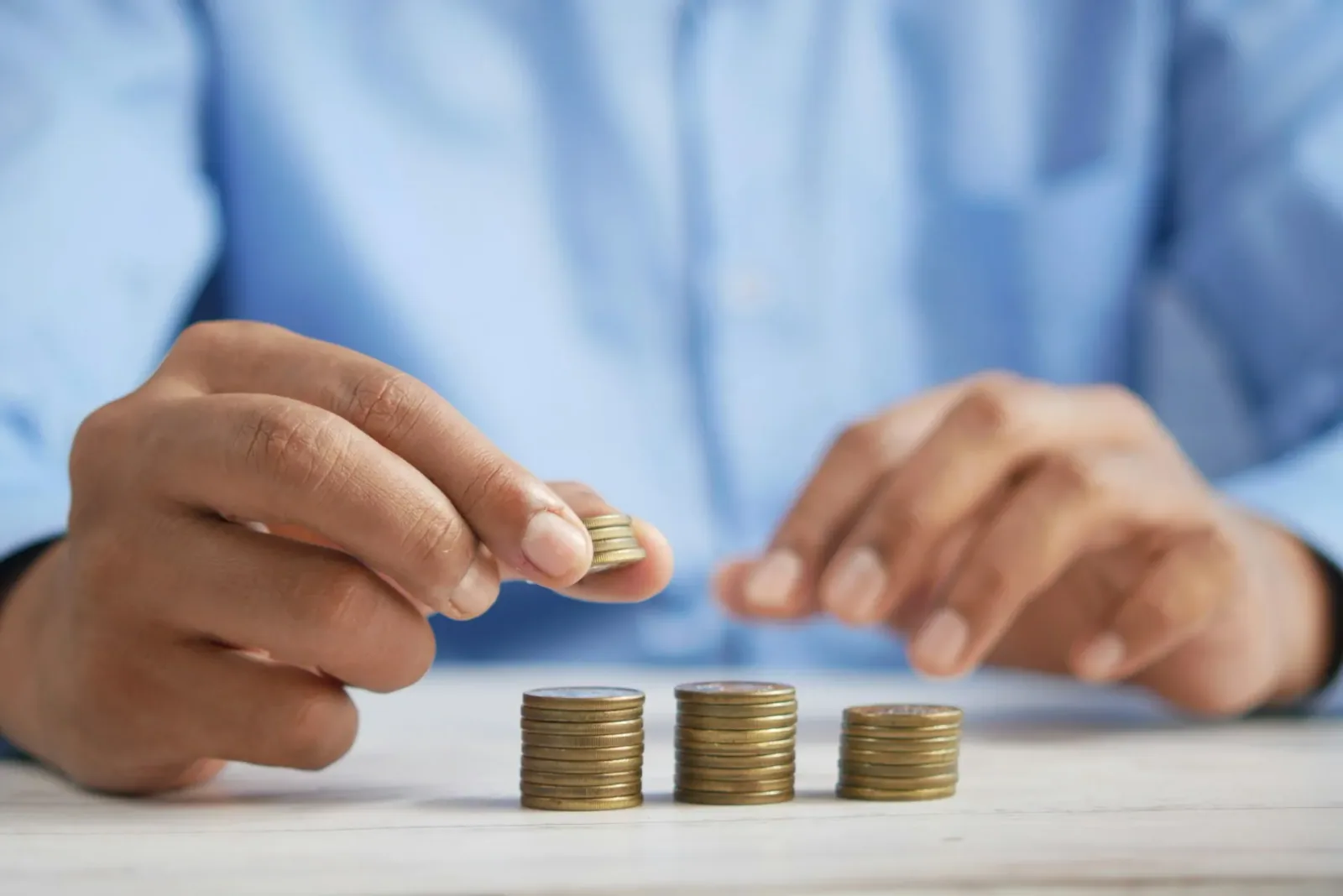 Hands stacking coins for financial planning saving money