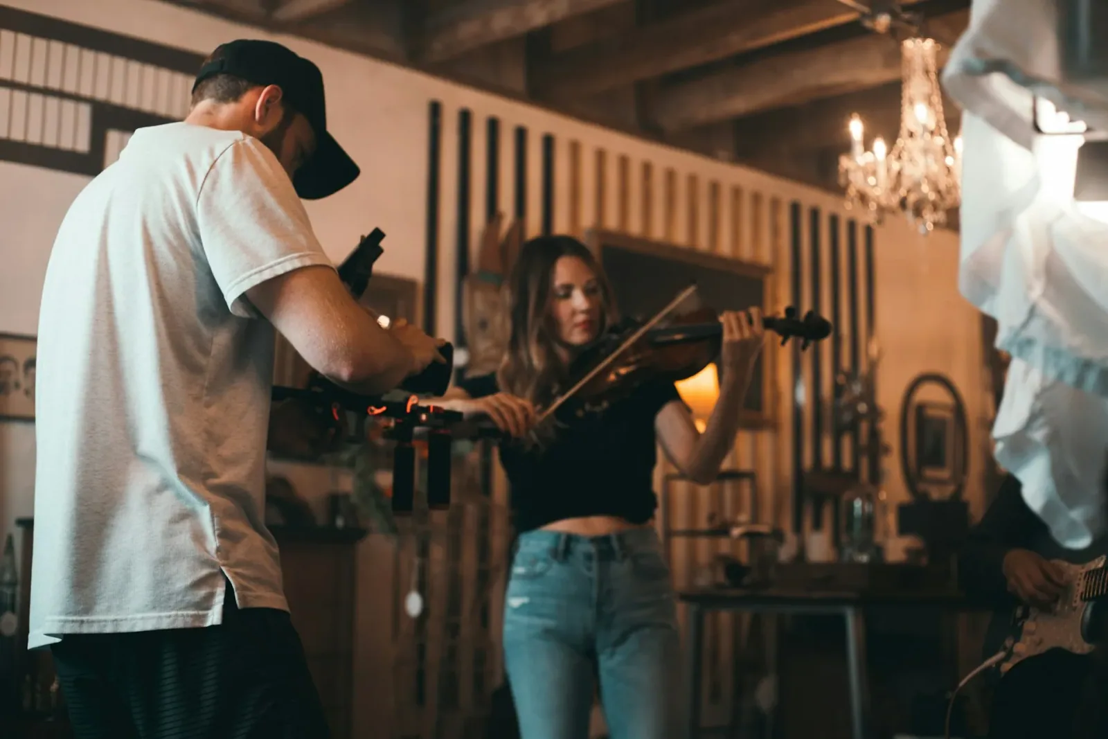Female violinist playing during a professional recording session in a warm indoor studio