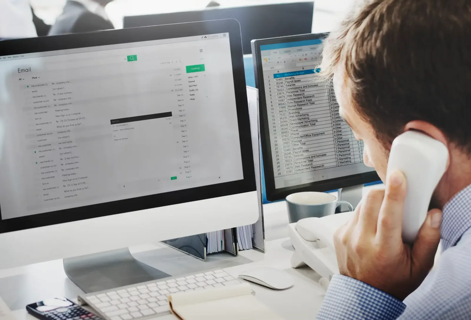 Customer support representative managing emails and providing phone assistance in a modern office environment