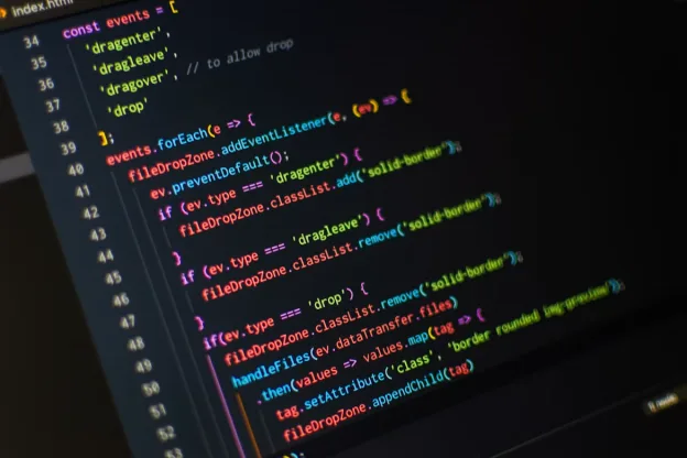 Code editor displays colorful JavaScript drag-and-drop event handling on a dark screen.