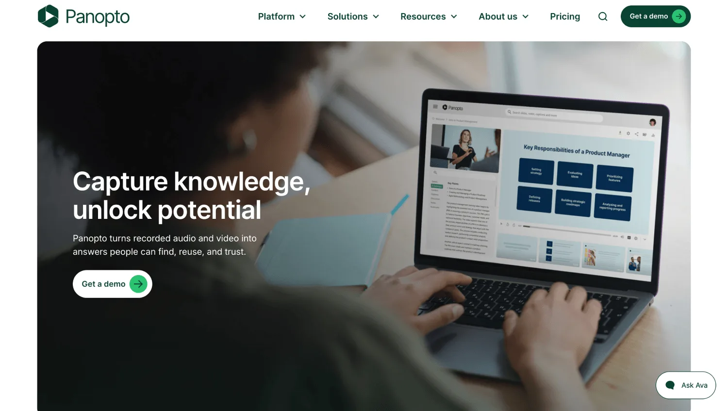 Laptop displays a knowledge-sharing webpage while a person types, beneath a darkened banner with white promotional text.